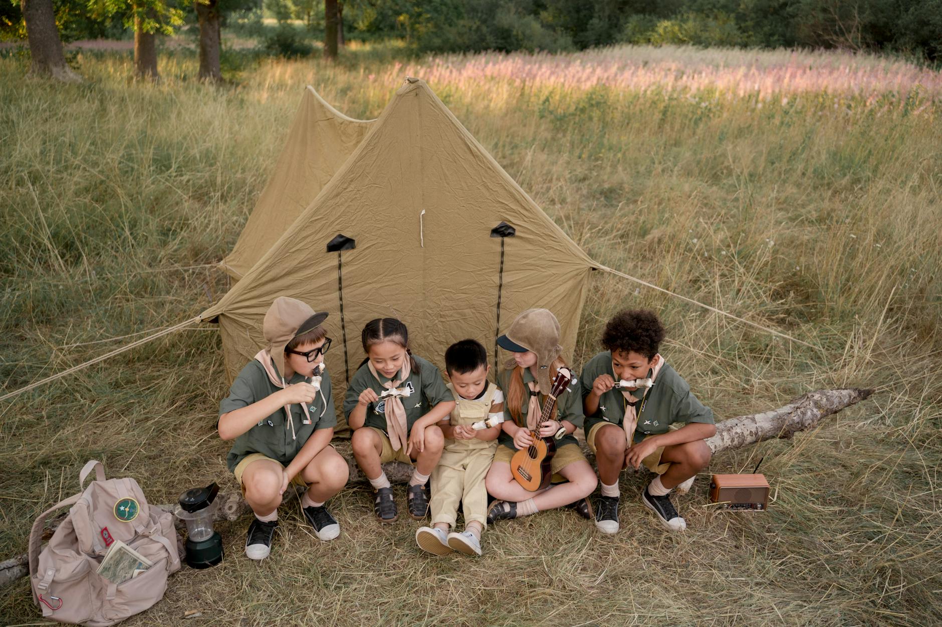 young scouts eating skewered marshmallows